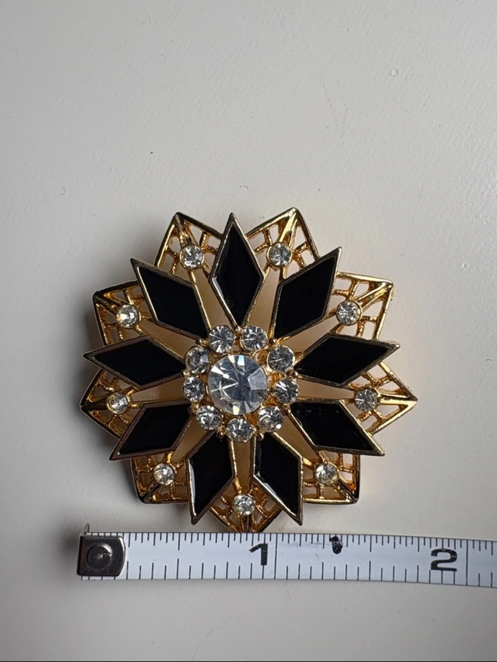 Vintage Gold Tone Black Enamel Starburst Brooch with Clear Rhinestones